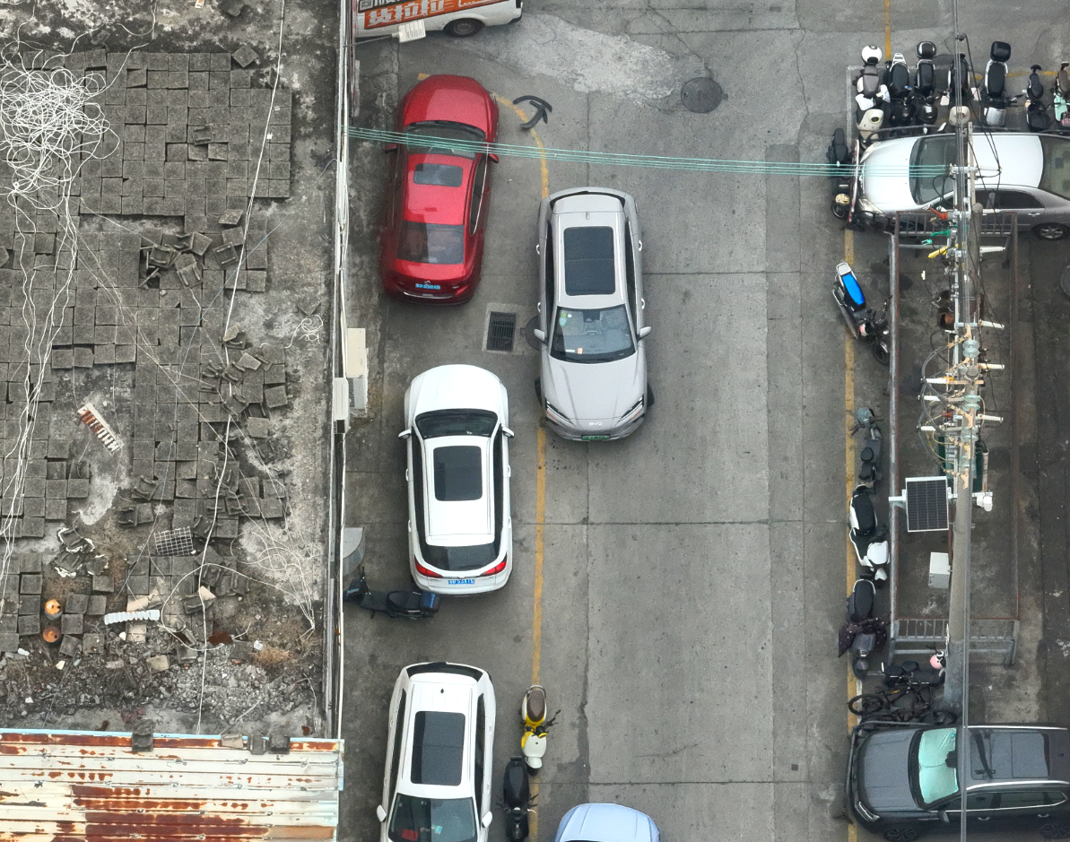Aerial view of vehicles moving through an urban intersection