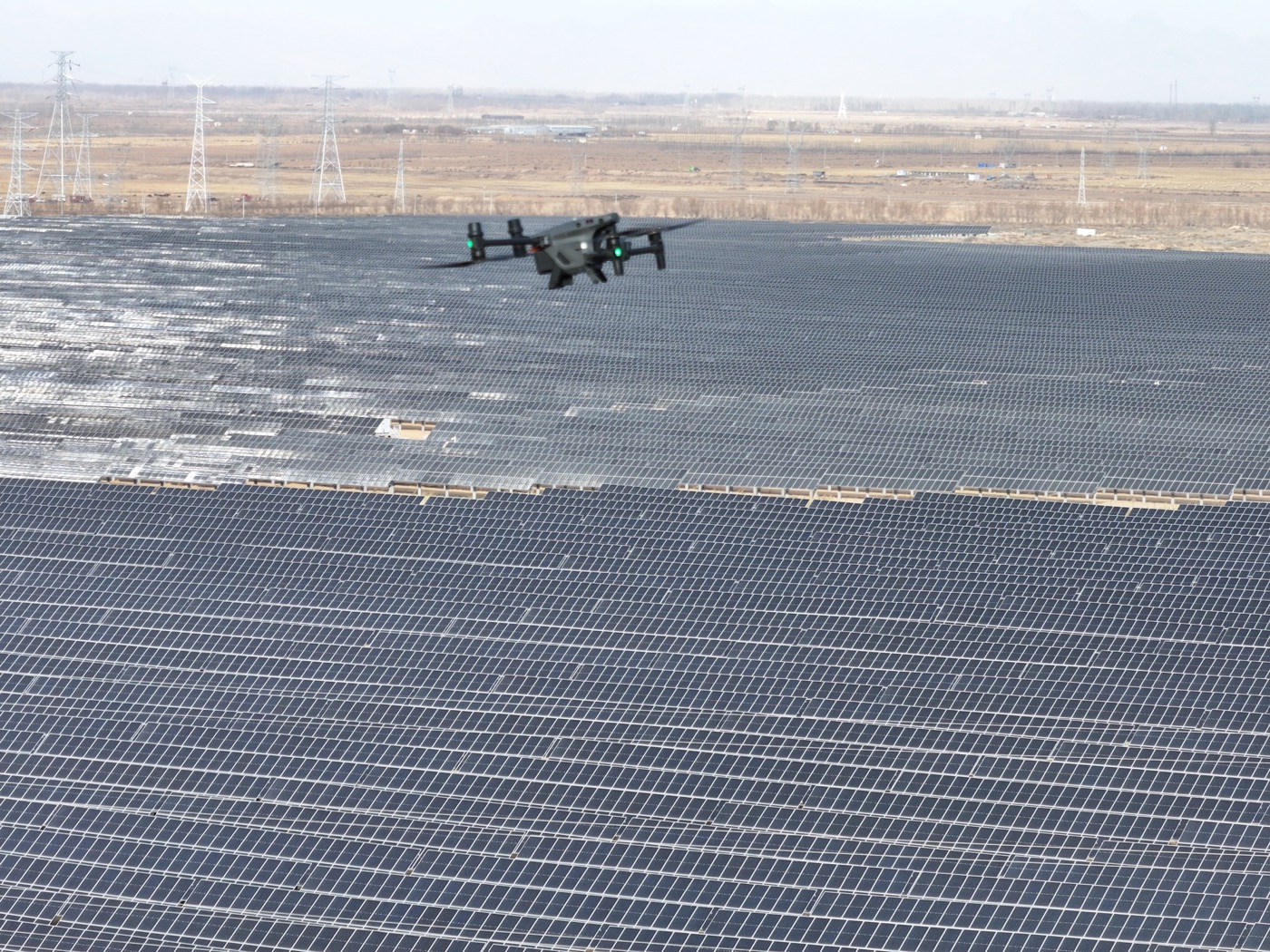 Drone inspecting rows of solar panels