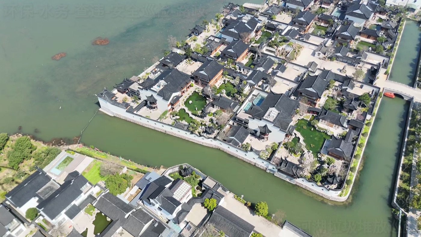 Aerial view of a lakeside resort and surrounding landscape